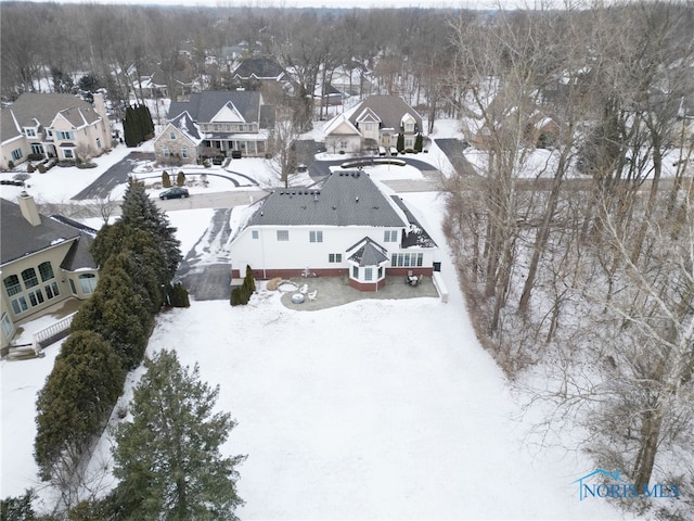 snowy aerial view featuring a residential view