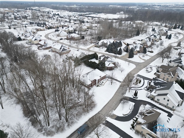 snowy aerial view with a residential view