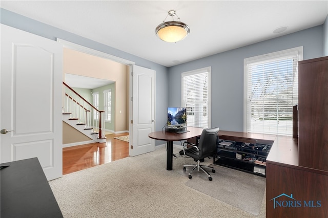 home office featuring baseboards and carpet