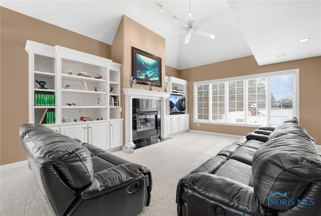 living room with lofted ceiling, light colored carpet, a tiled fireplace, and baseboards