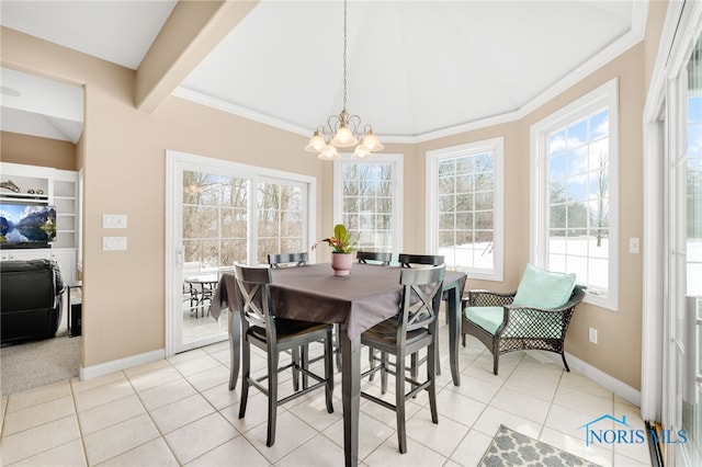 dining space with a notable chandelier, baseboards, crown molding, and light tile patterned floors