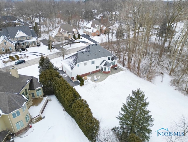 snowy aerial view featuring a residential view