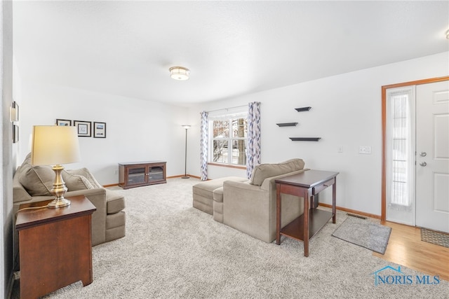 living room with wood finished floors and baseboards