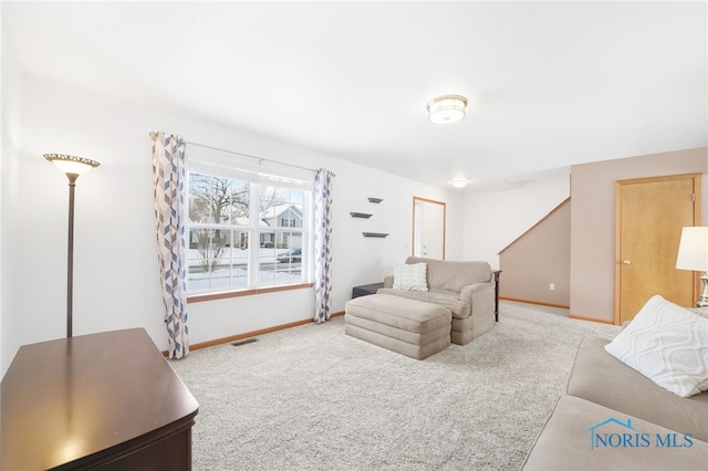 living room with light carpet, baseboards, and visible vents