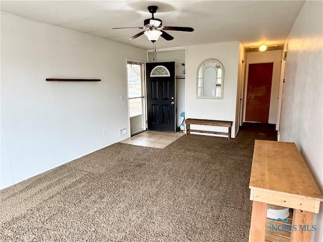 carpeted entryway with a ceiling fan