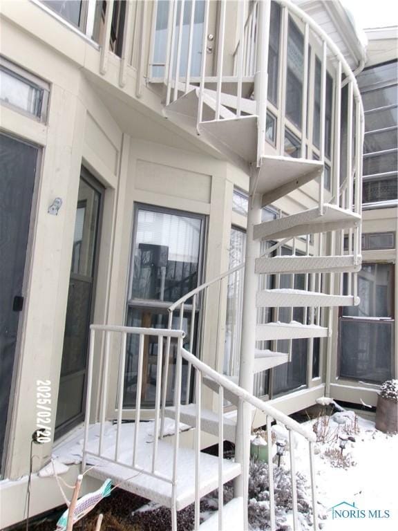 view of snow covered property entrance