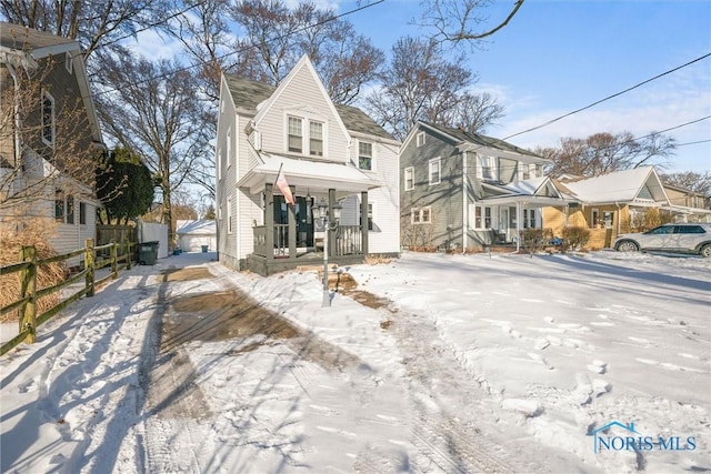 view of front of property with a garage, a residential view, fence, and a porch