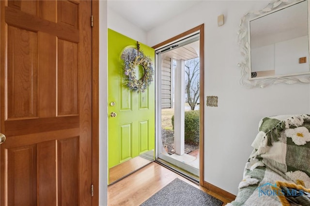 entryway with baseboards and wood finished floors