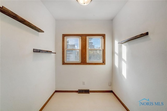 empty room featuring visible vents and baseboards