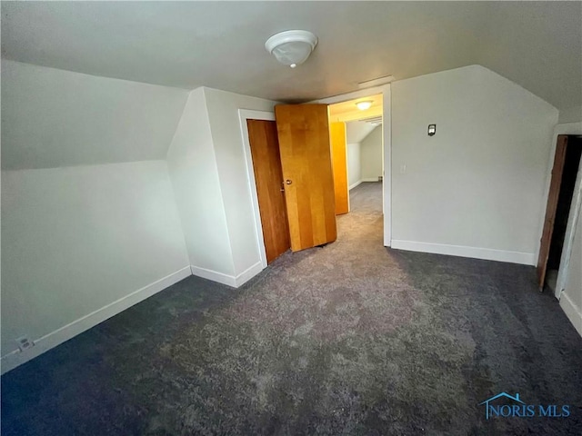 bonus room with vaulted ceiling, carpet flooring, and baseboards