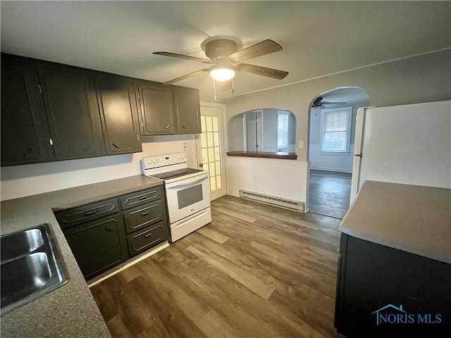 kitchen featuring arched walkways, a baseboard radiator, white appliances, dark wood-style flooring, and a sink