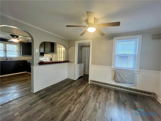 unfurnished room with arched walkways, ornamental molding, dark wood-style flooring, and a baseboard radiator