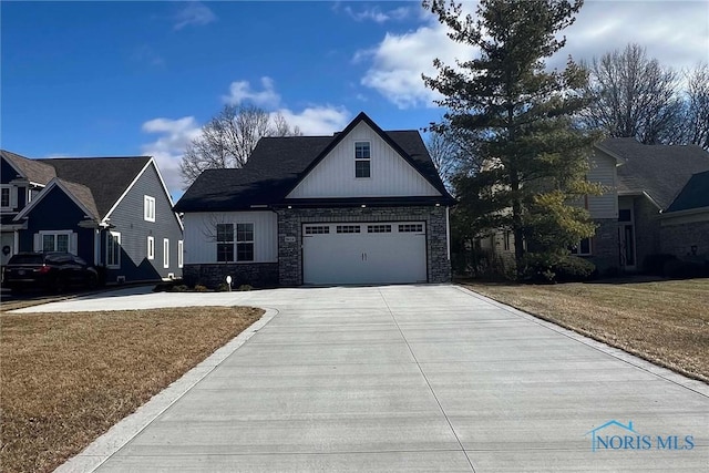 view of front facade with an attached garage, stone siding, concrete driveway, and a front yard