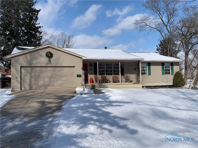 ranch-style home with a garage, driveway, and a porch