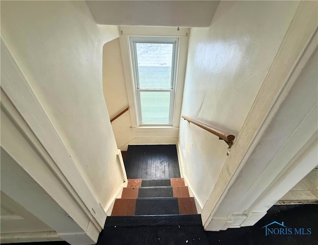 stairway with wood finished floors