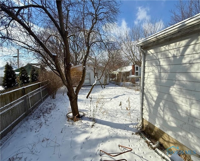 yard layered in snow with fence