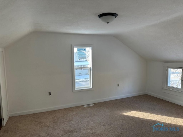 bonus room with carpet flooring, visible vents, and baseboards