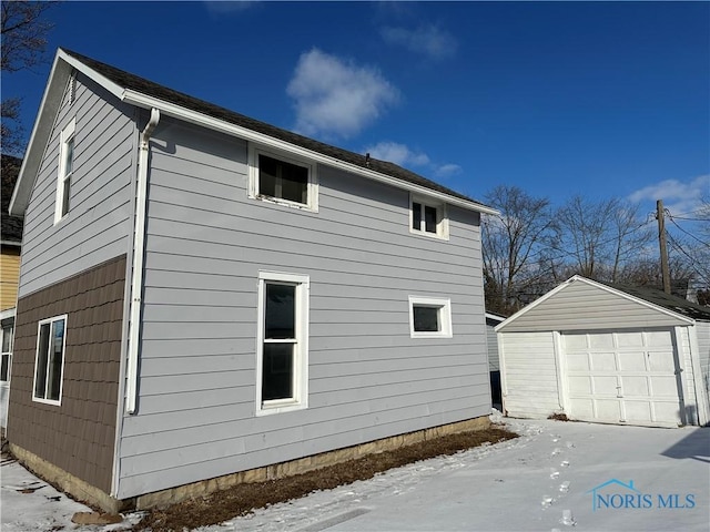 view of side of property with an outbuilding and a detached garage