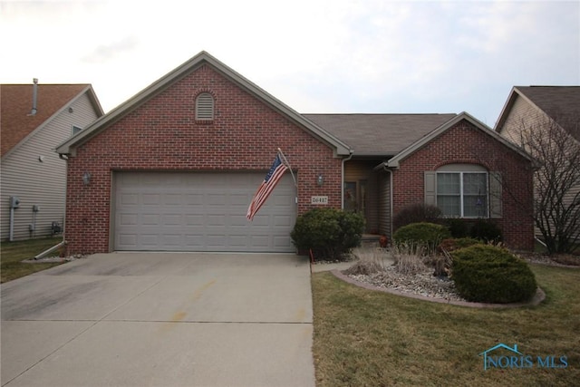 ranch-style home featuring a front lawn, brick siding, driveway, and an attached garage