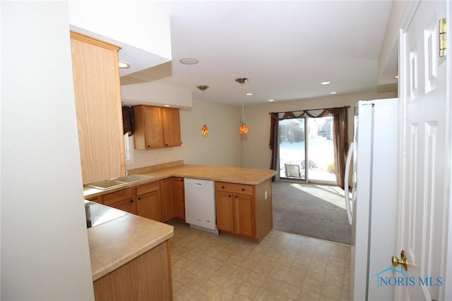 kitchen with white appliances, a peninsula, light countertops, light floors, and pendant lighting