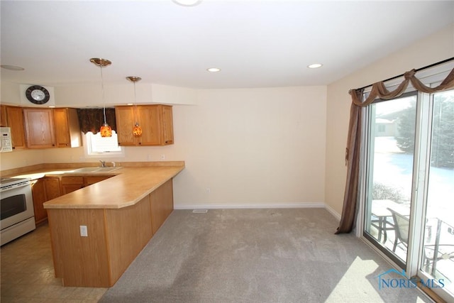 kitchen featuring white appliances, brown cabinetry, decorative light fixtures, a peninsula, and light countertops