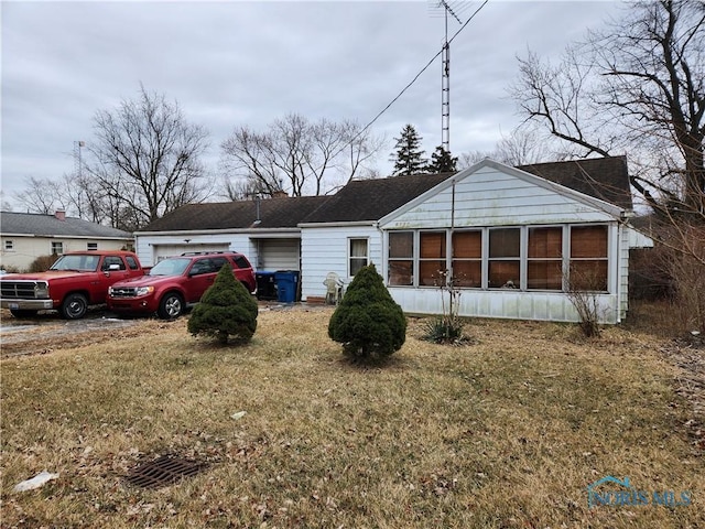 exterior space featuring a garage and a front lawn