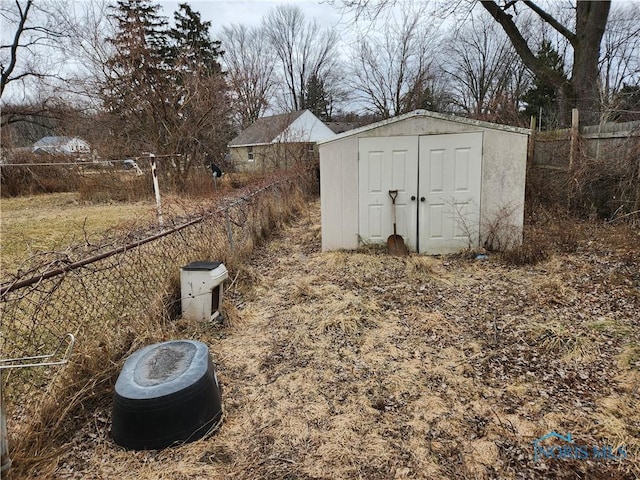 view of shed featuring fence