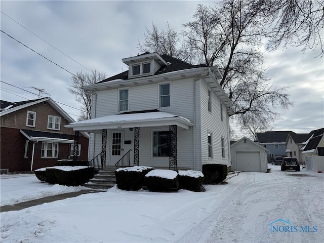 american foursquare style home with a porch, a detached garage, and an outdoor structure