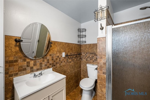 full bath with tile patterned flooring, toilet, vanity, tile walls, and a stall shower