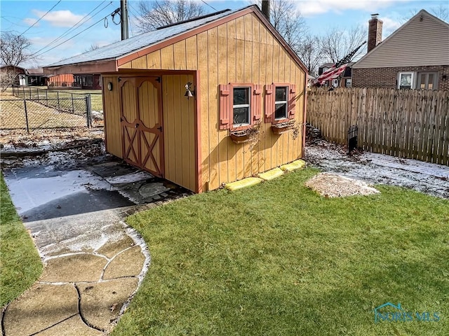 view of shed featuring fence