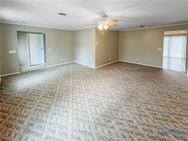 carpeted empty room with ceiling fan, baseboards, visible vents, and crown molding