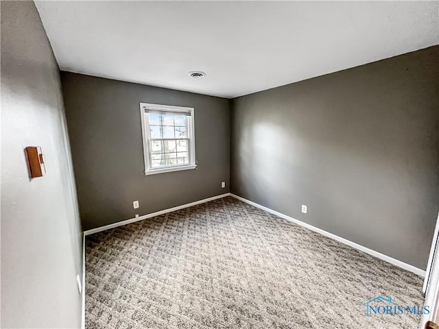 carpeted empty room with visible vents and baseboards