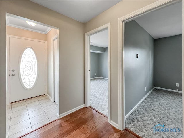 foyer with light wood finished floors and baseboards