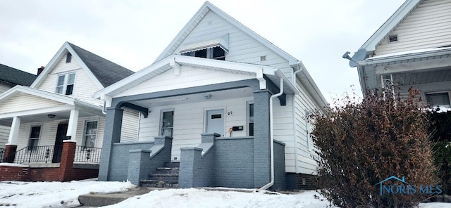 view of front of property with covered porch and brick siding