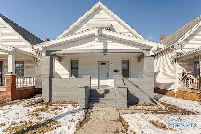 view of front of property with a porch and brick siding