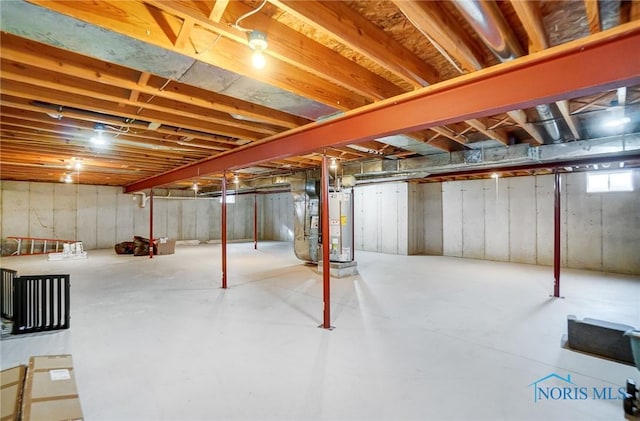 unfinished basement featuring heating unit