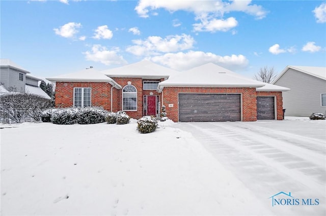 view of front of house with brick siding and an attached garage