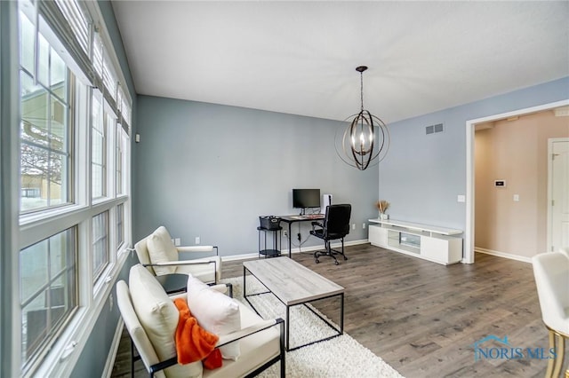 home office with a chandelier, visible vents, baseboards, and wood finished floors