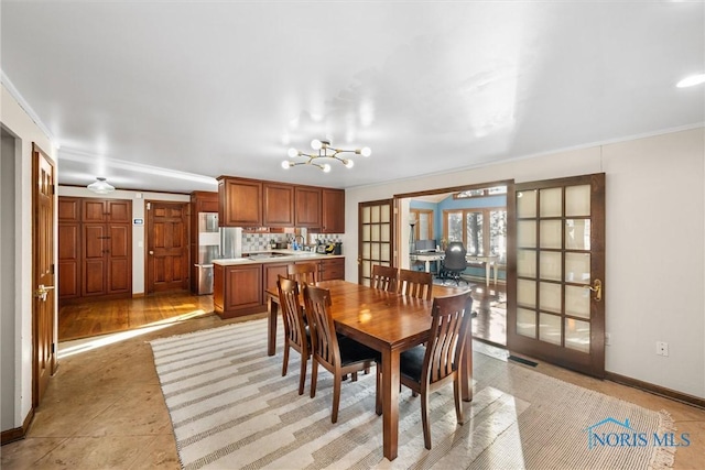 dining area featuring visible vents, baseboards, crown molding, and french doors