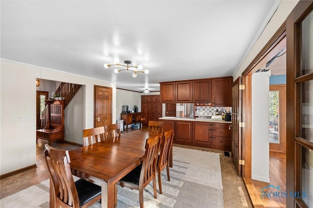 dining room featuring stairs and baseboards