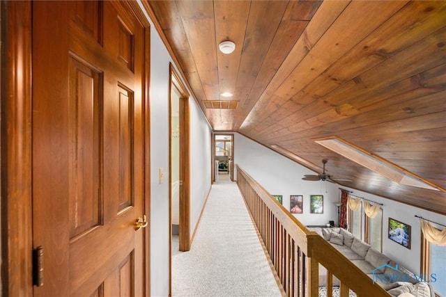 corridor with wood ceiling, carpet flooring, vaulted ceiling, and visible vents