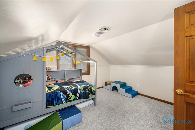 carpeted bedroom with lofted ceiling, baseboards, and visible vents