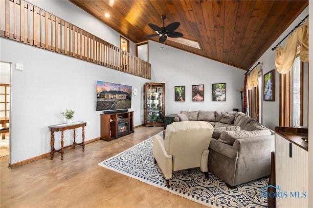 living area featuring high vaulted ceiling, wooden ceiling, a glass covered fireplace, and baseboards