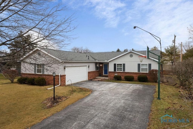 single story home with a garage, driveway, brick siding, and a front yard