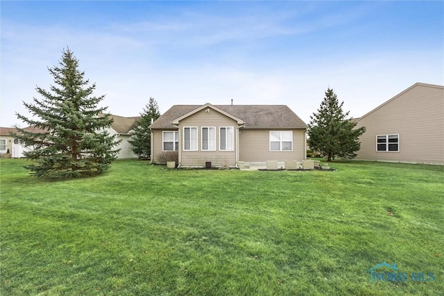 rear view of house with a yard