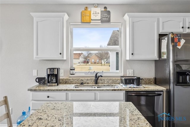 kitchen featuring white cabinetry, dishwasher, stainless steel refrigerator with ice dispenser, and a sink