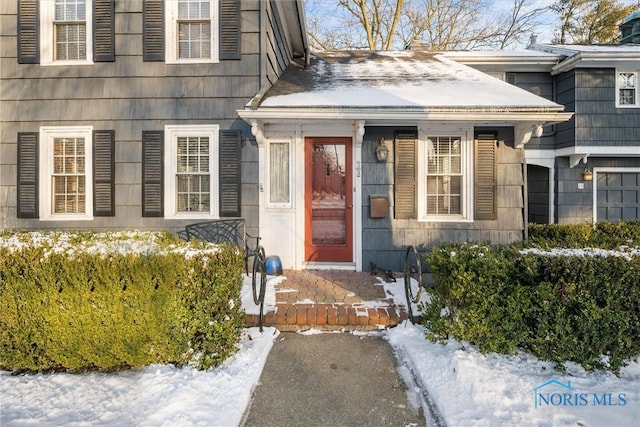 view of snow covered property entrance