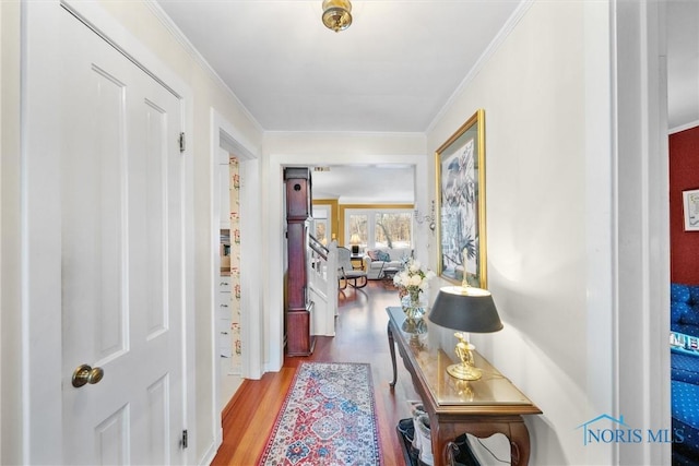 hallway featuring light wood-type flooring and crown molding