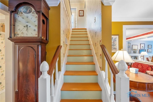 staircase featuring crown molding