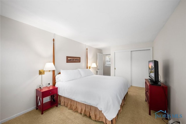 bedroom with a closet, carpet, and baseboards